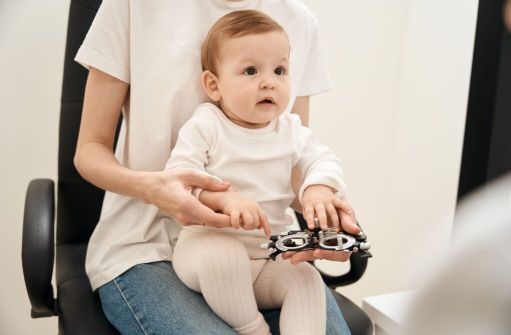 A baby at the eye doctor having a pediatric eye exam to monitor for refractive errors, like astigmatism.