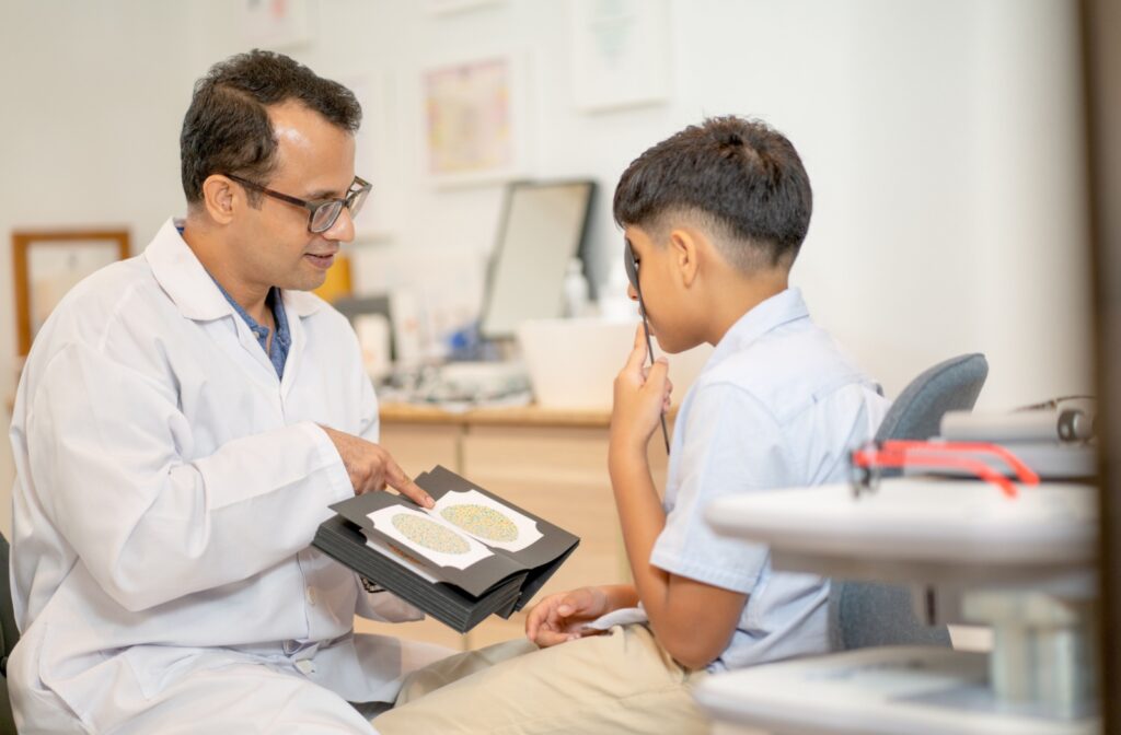 An eye doctor testing a child for color blindness during a comprehensive eye exam.